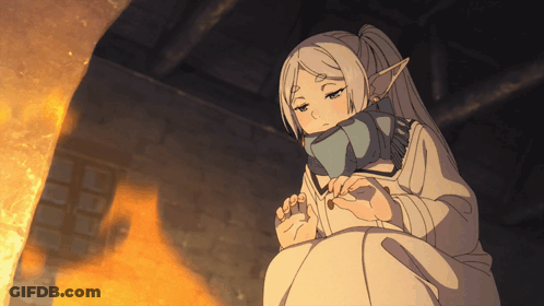 Girl With Scarf Sitting In Front Of Fireplace GIF