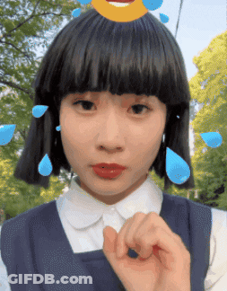 Girl With Smiley Face On Head Making Hand Gesture GIF