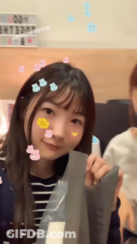 Girl With Stickers Holding Paper Smiling GIF