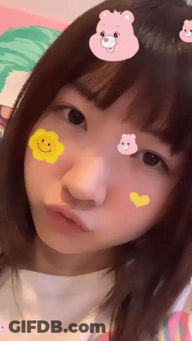 Girl With Stickers On Face Including Pink Bear GIF