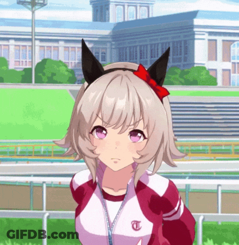 Girl With T On Jacket In Front Of Large Building GIF
