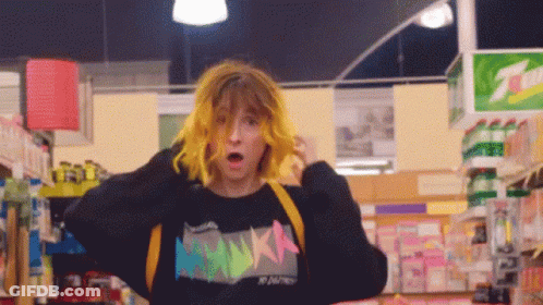 Girl With Yellow Hair In Black Sweater Saying Nikka GIF