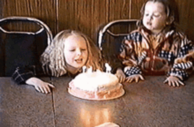 Girls Blowing Birthday Candles On Cake GIF
