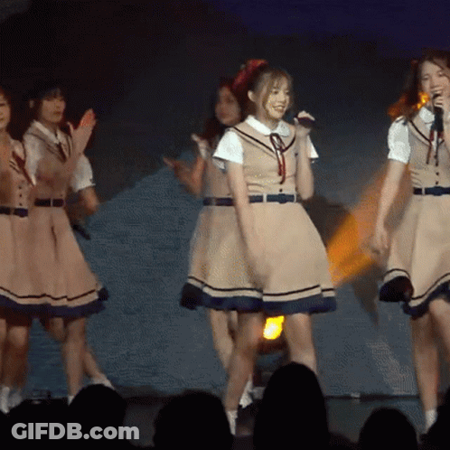 Girls In School Uniforms Singing Into Microphones GIF