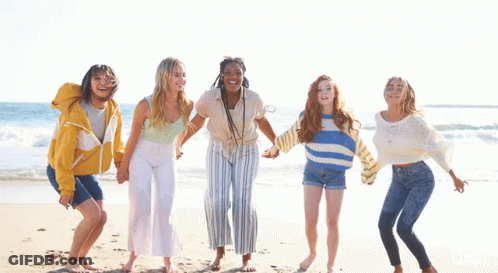 Girls Jumping In Air On Beach GIF