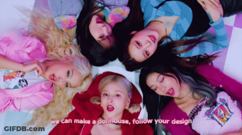 Girls Laying In Circle With Dollhouse Design GIF