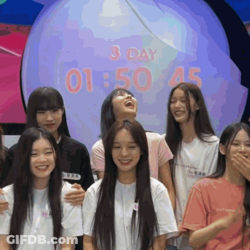 Girls Posing In Front Of 3 Day 1:50 Clock GIF