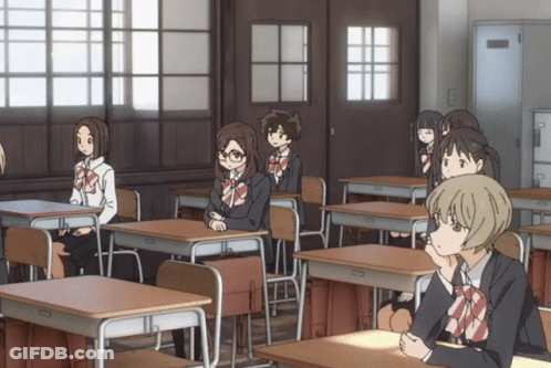 Girls Sitting At Desks In Classroom GIF