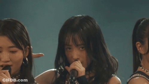 Girls Standing On Stage With Fists In Air GIF