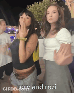 Girls Standing Together One Pointing GIF