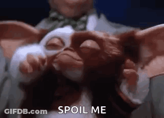 Gizmo Held By Man In Suit And Tie GIF