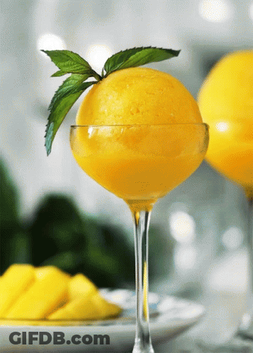 Glass Of Yellow Ice Cream With Mint Leaf GIF