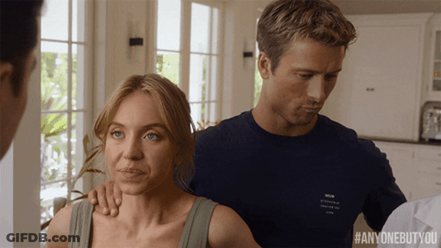 Glen Powell Sydney Sweeney Rubbing Shoulder GIF