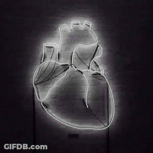 Glowing Neon Human Heart On Brick Wall GIF