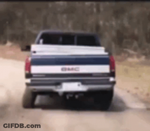 GMC Truck Driving On Dirt Road GIF