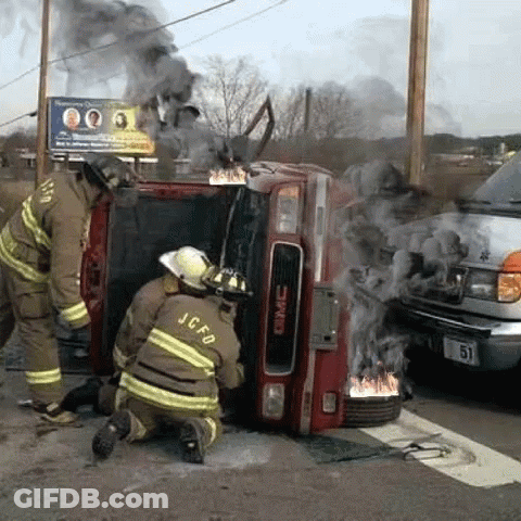 GMC Truck On Fire With Two Firefighters Kneeling GIF