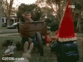 Gnome In Red Hat Laughing And Covering Mouth GIF