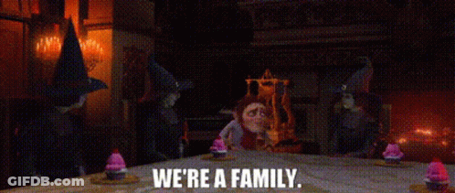 Gnomes Standing Around Table Saying We're A Family GIF