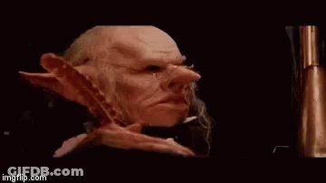 Goblin Face Close Up With Beard And Long Ears In Dark Room GIF
