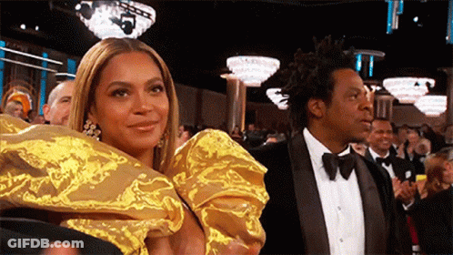 Gold Dress Woman And Tuxedo Man At Awards GIF