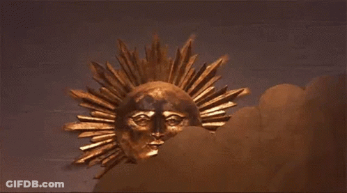 Gold Sun With Face Hanging On Wall GIF