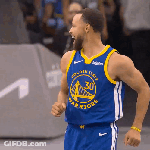Golden State Warriors Basketball Player Stephen Curry Wearing A Blue And Yellow Jersey GIF
