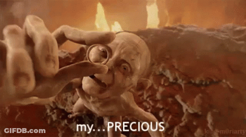 Gollum From The Lord Of The Rings Is Holding A Ring In His Hand And Says `` My Precious '' . GIF