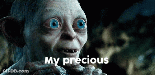 Gollum From The Lord Of The Rings Is Holding Something In His Hand And Says My Precious GIF