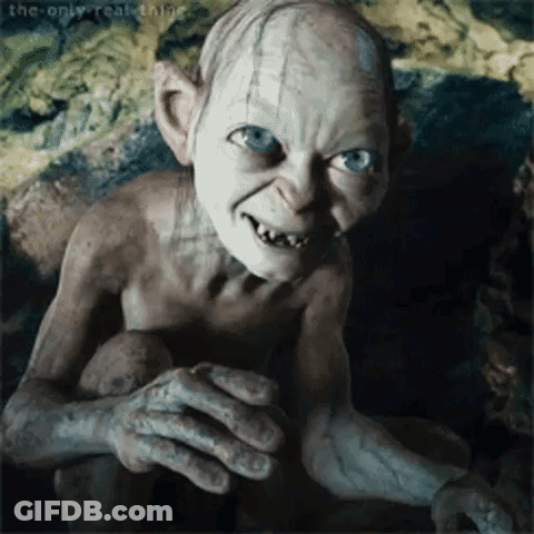 Gollum From The Lord Of The Rings Is Smiling And Looking At The Camera While Sitting On A Rock . GIF