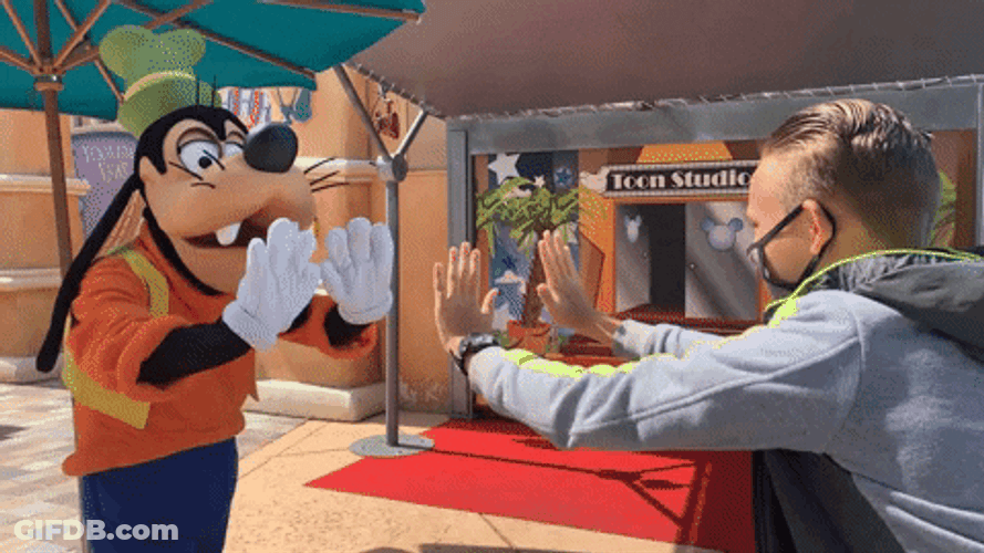 Goofy And Man High Five In Disneyland GIF