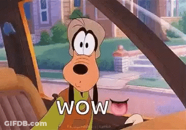 Goofy Is Sitting In The Driver 'S Seat Of A Car . GIF