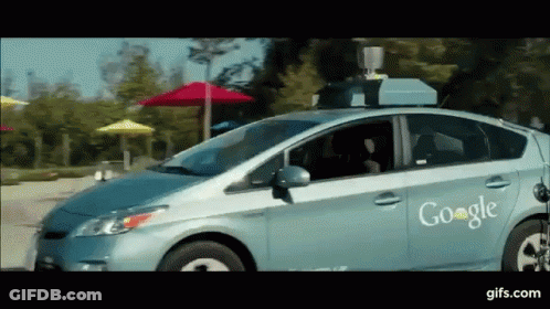 Google Car Driving Down Street With Umbrellas GIF