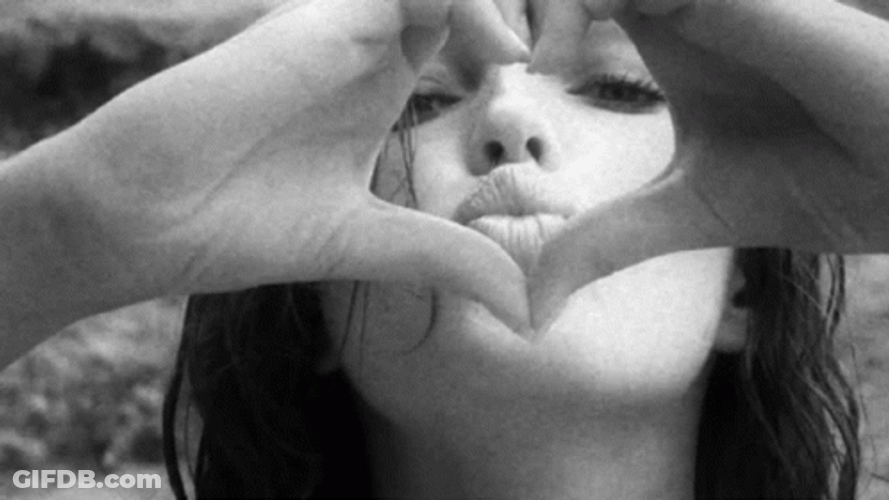 Gorgeous Lady Blows Kiss Inside Heart Hands GIF