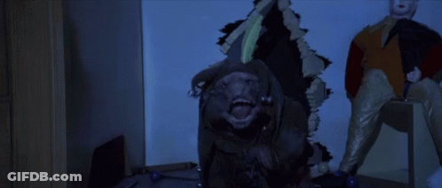 Gorilla Statue Holding Knife With Clown GIF