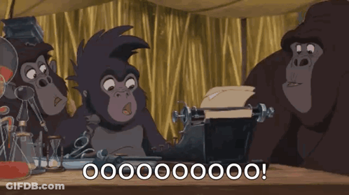 Gorillas Sitting Around Table With Typewriter GIF