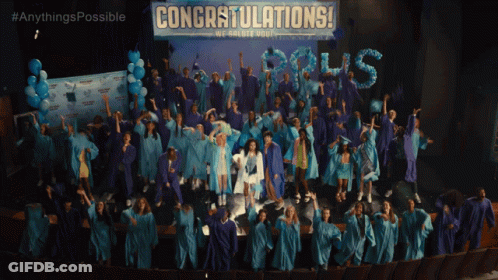 Graduates Standing In Front Of Congratulations Banner GIF
