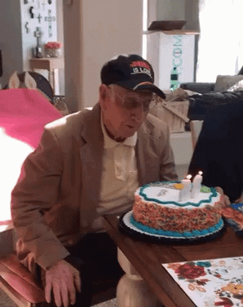 Grandpa Blows Happy 65Th Birthday Cake GIF
