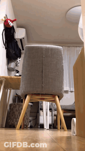 Gray Chair Next To Table And Fan GIF