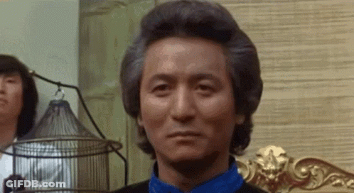 Gray Haired Man In Blue Shirt Sitting On Chair GIF