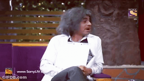 Gray-Haired Man Sitting On Couch With Sony Logo GIF