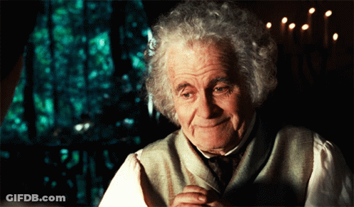 Gray-Haired Man Smiling By Window With Candles GIF
