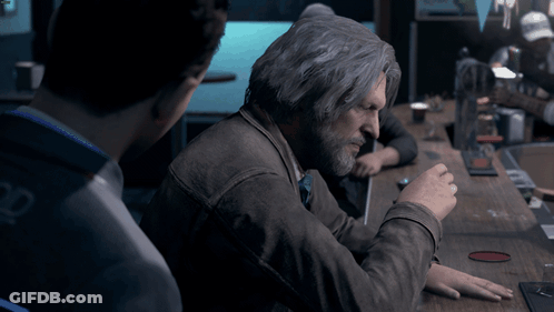 Gray-Haired Man With Beard Sitting At Table GIF