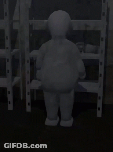Gray Teletubbies Character Standing In Front Of Shelves GIF