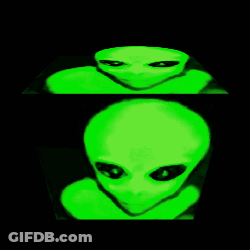 Green Alien With Black Eyes Looking At Camera GIF