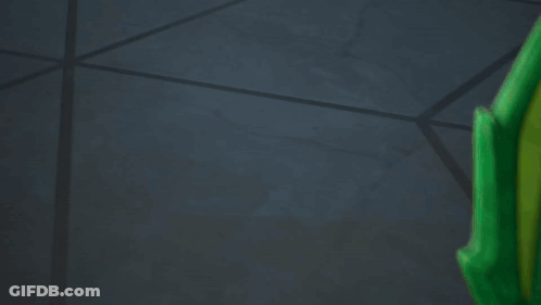 Green And Gold Toy Dragon With Black Mask GIF