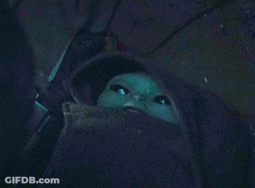 Green Baby With Beard Looking Up In Dark GIF