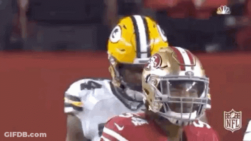 Green Bay Packers And San Francisco 49Ers Football Players Standing On Field GIF