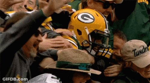 Green Bay Packers Player Surrounded By Fans With G Helmet GIF