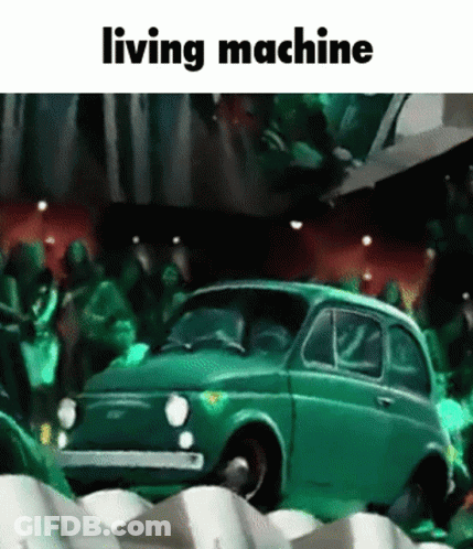 Green Car In Front Of Crowd Saying Living Machine GIF