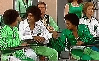 Green-Clothed People Sitting At Tables GIF